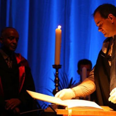 Photograph: Reading names from the Book of Remembrance at the 2014 UQ Thanksgiving Ceremony.