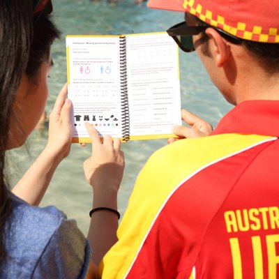 A beachgoer points to the missing person's section 