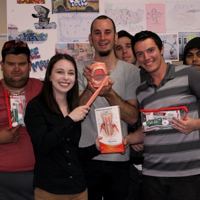 Nicole Cockburn of UQ Dentistry (front) with clients and staff from Brisbane Youth Services, the venue for Dental Rescue Week.