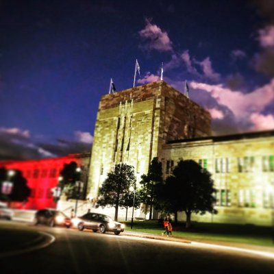 UQ's Forgan Smith building lit in Aboriginal flag colours.