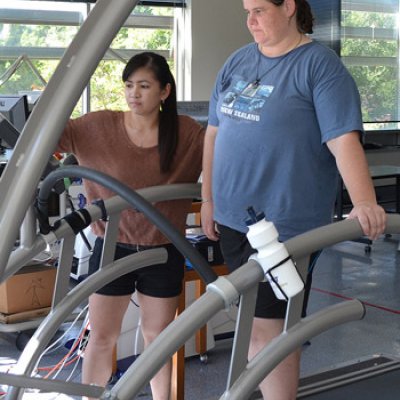 Joyce Ramos helps Karen O'Brien work the treadmill controls