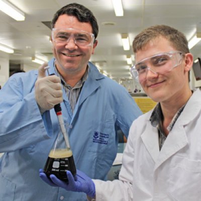 UQ's Dr James Fraser and student Cody Price dabble in the art of Guinness beer brewing.