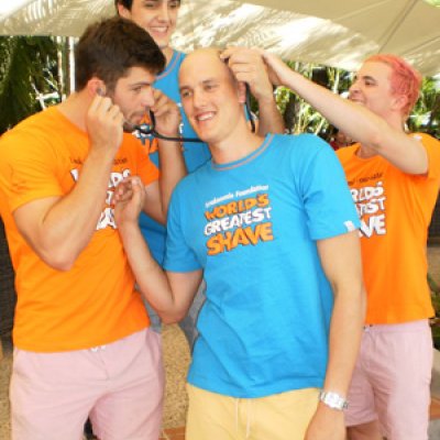 Team Maunder gets ready to "be brave and shave" in front of crowds at Regatta Hotel to raise funds for the World’s Greatest Shave campaign. (Left in orange, Kane Boucaut, back in blue, Louis Stephen, middle in blue John Maunder and right in orange Mac Alison.) Photo by Kate Bishop.