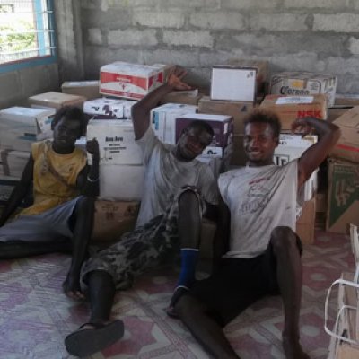 Avu Avu locals helped carry the shipment of books up to the school.