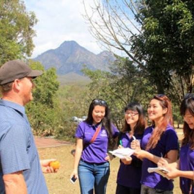 Students Amy Yuchen Li, Joanne Fang, Crystal Ip and Cici Chan talk to a local business operator. Photo by Brent Randall