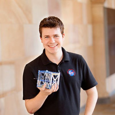 Michael Kehoe, UQ final year student of the School of Information Technology and Electrical Engineering. Pictured with his final year thesis project, a satellite that uses Android mobile phone technology as its on-board computer. Michael has recently completed a five week-internship with NASA. He has built a phonesat that will be launched by NASA into space on November 25.