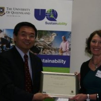 Jenny Hall of the UQ Dentistry Library receives an award for the Best Green Office Initiative from Senior Deputy Vice-Chancellor Professor Max Lu. Photo: Stuart Green