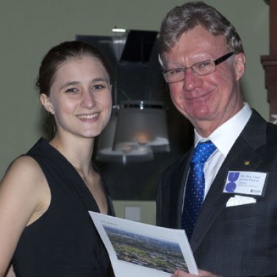 Chief Justice of Queensland Paul de Jersey AC presents the Dr MHM Kidwai Memorial Prize to UQ law student Tegan Stockdale.
