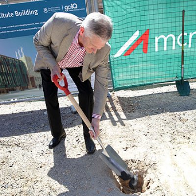 Visionary philanthropist Graeme Wood buries a piece of coal in front of the construction site of the Global Change Institute Living Building at St Lucia