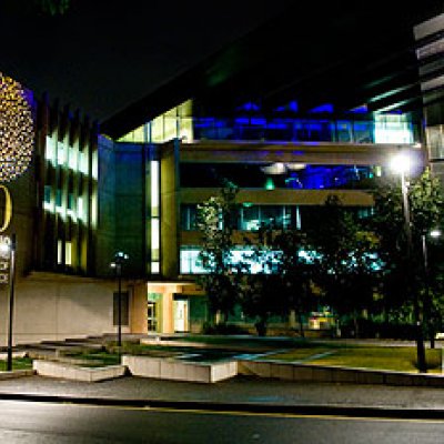 The exterior of the Sir Llew Edwards Building lit to celebrate ICTE-UQ's 30th anniversary