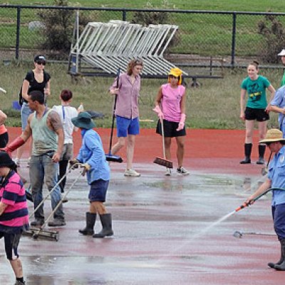 Volunteers help clean up the UQ Athletics Centre at St Lucia following the floods