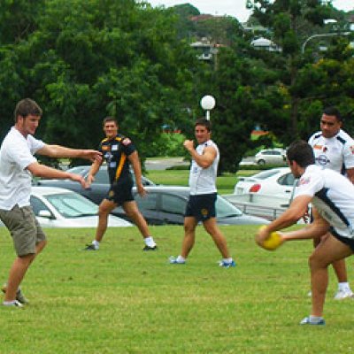 UQ Sport staff enjoy a game of touch football with Brisbane Broncos players