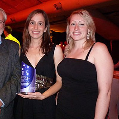 Professor John Minnery with winning students Isabel Ceron Castano and Heather Lopez