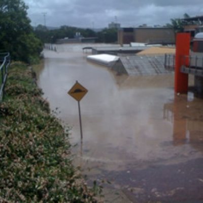 Floodwaters over Glasshouse Road at UQ's St Lucia campus. Picture: Geoff Dennis.