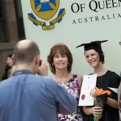 UQ graduates taking family photos in front of the new plinths following graduation ceremonies at the St Lucia campus.