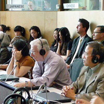 Guests listen to live interpreting in Japanese and Chinese at the opening of the newly refurbished JM Campbell Conference Facility