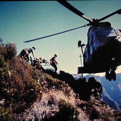 Commander Luckin takes part in a rescue at 10,000 feet in the Drakensberg Mountains, South Africa. With nowhere to land, the pilot has balanced the helicopter on one wheel on a rock