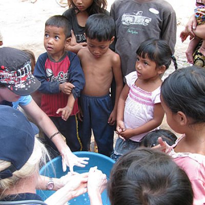 UQ students complete a hand washing demonstration with children in Siem Reap, Cambodia. Image: Peta Crompton
