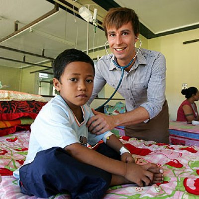 UQ medical student Bayden Sales checks on Tamasipini Palenapa, 5, at Apia Hospital. Photo Bruce Long, The Courier-Mail