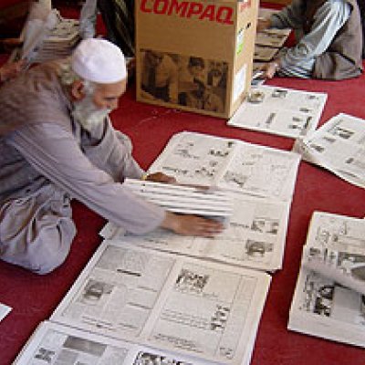 Hand-compiling the Kabul Weekly newspaper. 
© UNESCO/M.Hadlow.