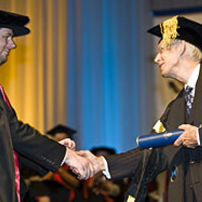Dr White (left) receiving his PhD from Chancellor Sir Llew Edwards last December