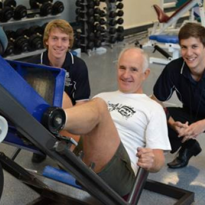 Prostate cancer survivor, John Brady, participating in exercise session with UQ Clinical Exercise Physiology students Nicholas Edwards(left) and Daniel Harth (Right)