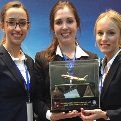 UQ law students, from left, Ella Rooney, Georgina Morgan and Amina Karcic with their trophy   