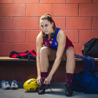 Grider laces up her boots in the change rooms.