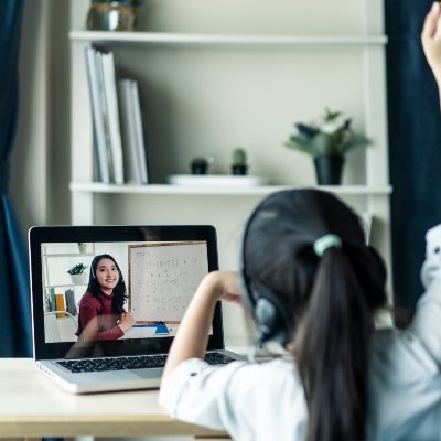 Young girl sitting at desk while being homeschooled.