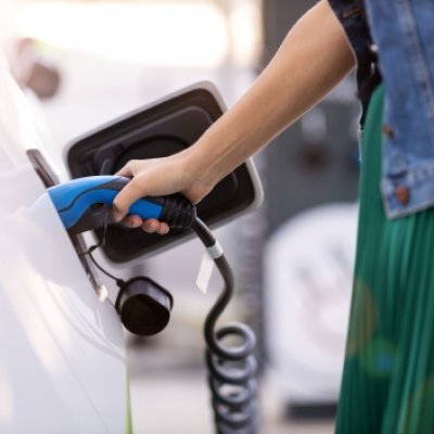 Person charging their electric vehicle. 