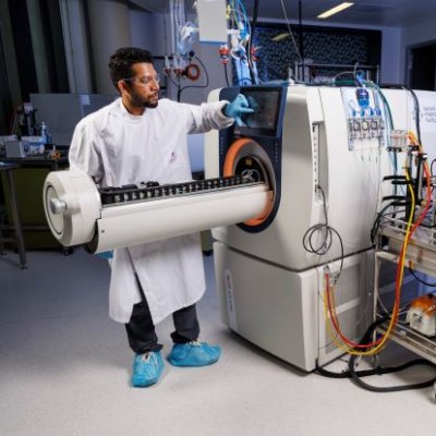 two researchers looking at a large machine