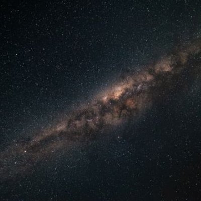 A photograph of the night sky with the Milky Way galaxy stretching out.