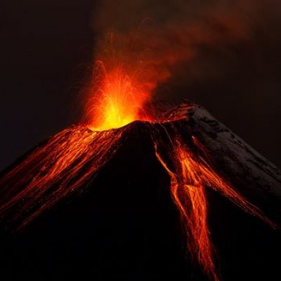 An erupting volcano at night. 