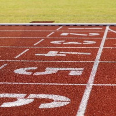 Red running track with white lines and number painted on.