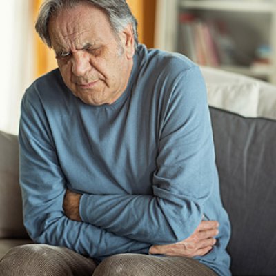 Man holding his lower abdomen in pain