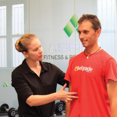 Molly Shevill helps a participant with the exercise program