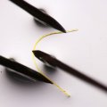 a fine yellow filament is bent between three black points