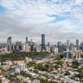 A wide view of a city skyline including high rises and residential housing