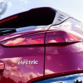 A photo of the back of a red car, with the word 'electric' on the bodywork.