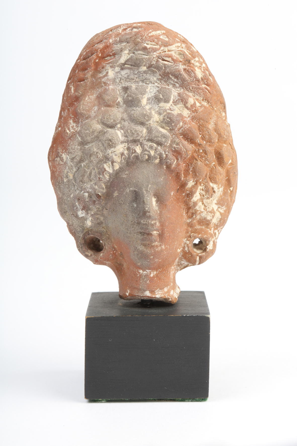 Figure of Woman with ‘bee-hive’ hairstyle, Terracotta, Roman, from Alexandria, Egypt, AD 1 – 200. Purchased from Charles Ede Ltd, London, 1973.