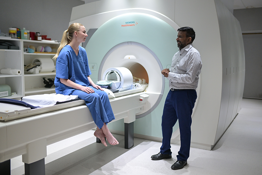 Shekhar Chandra with a patient at the University of Queensland’s Centre for Advanced Imaging