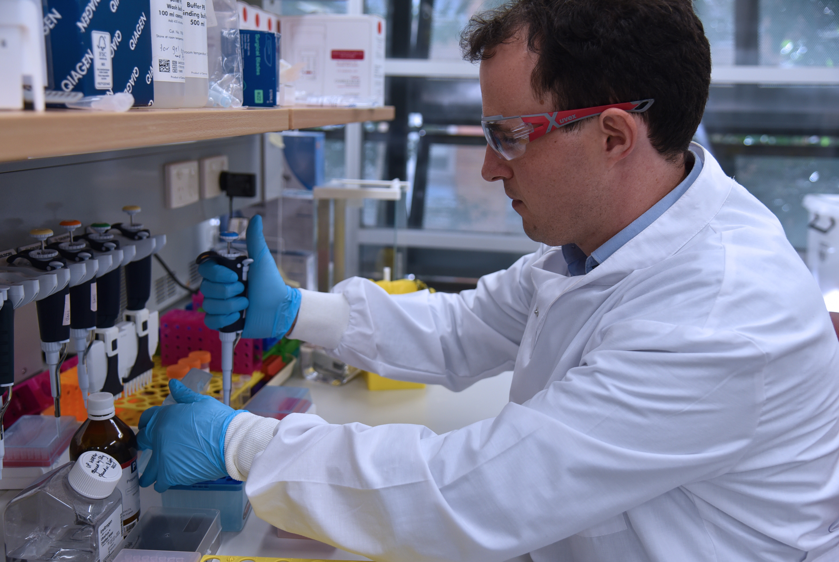 Dr Seth Cheetham working in a lab at UQ.