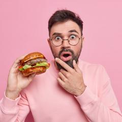 A man eating a fly burger