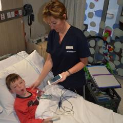 A doctor taking a child patient's temperature