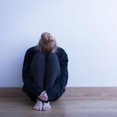 A sad girl sitting by herself