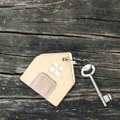 A key and small wooden house keychain