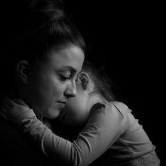 A solemn mother and her child in black and white