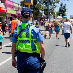 A police officer patrolling a busy street