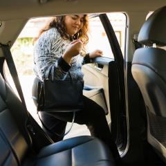 A woman enters a rideshare