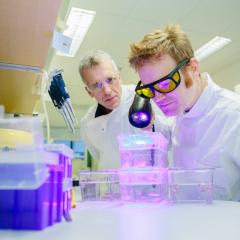 Professor Robert Parton in a lab with a colleague